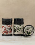 150g pair of cylindrical tea caddies in Japanese cherry blossom and pine wood design, by The Tea House