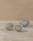 Stainless steel tea ball filters and chains in three sizes, by The Tea House