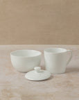 Three piece tea cupping set in white ceramic includes cup, lid and bowl, by The Tea House