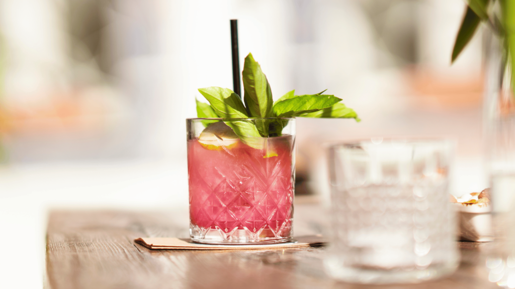 Fruity iced tea in a glass with straw.