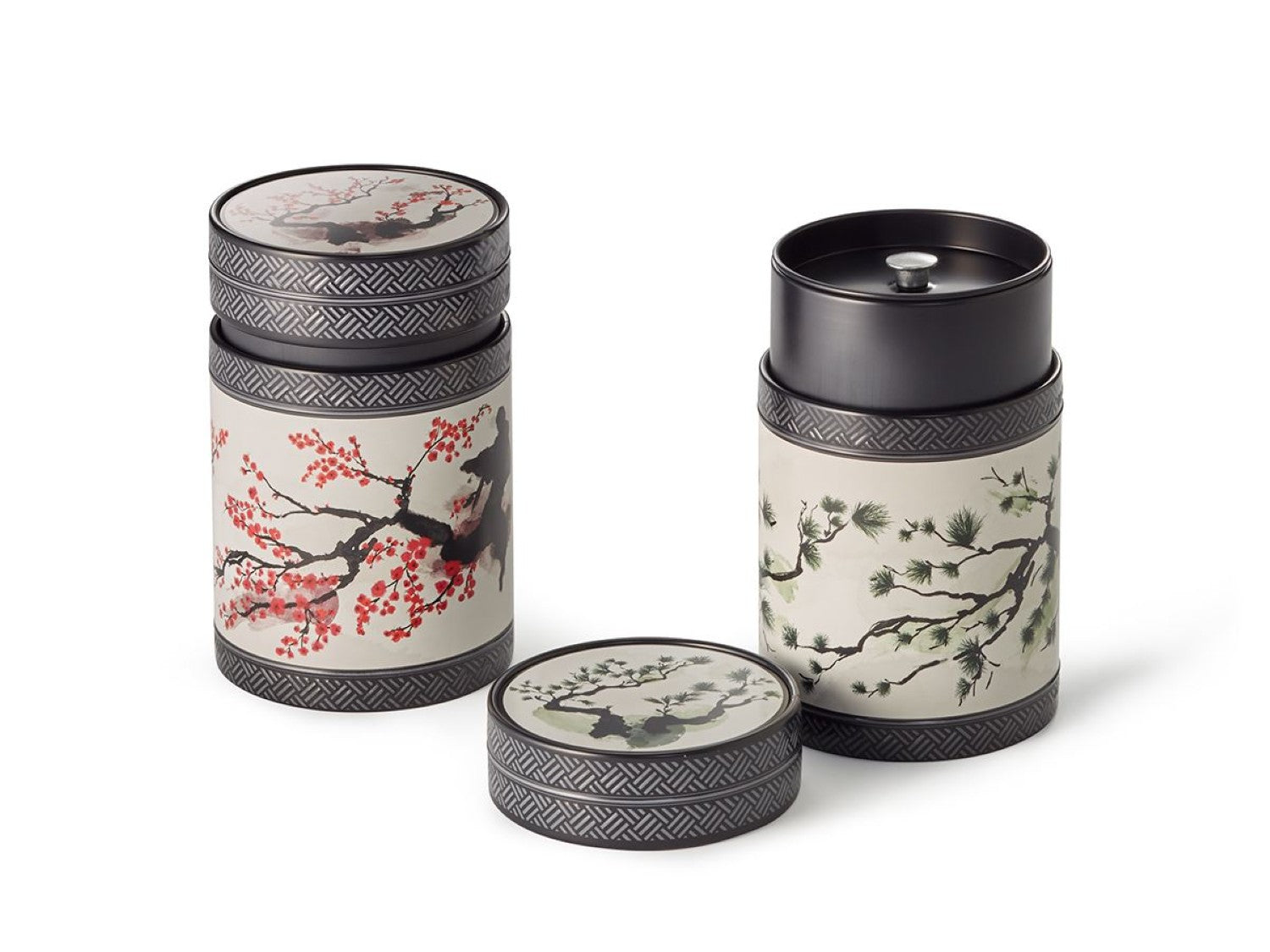 Pair of cylindrical tea canisters, elaborately decorated with pine and cherry blossom design with airtight inner lids 