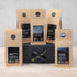Five packs of black tea on a black gift box with black and gold ribbon