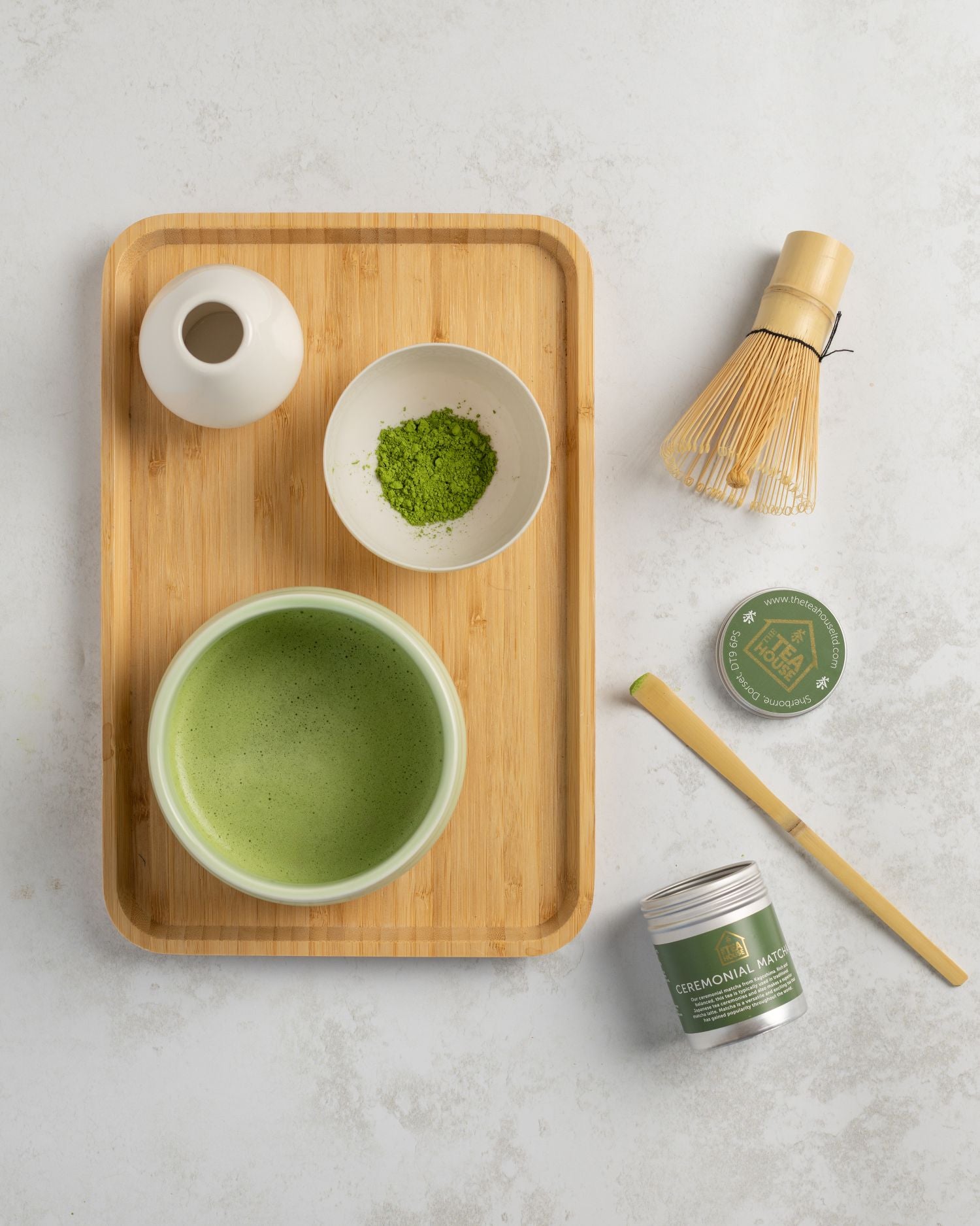 Matcha Tea preparation including matcha powder, bowl, spoon, whisk and whisk stand, by The Tea House