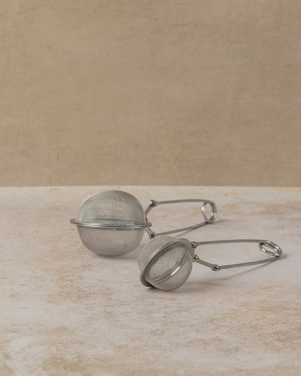 Stainless steel tea infuser tong with long sprung handle in two sizes, by The Tea House