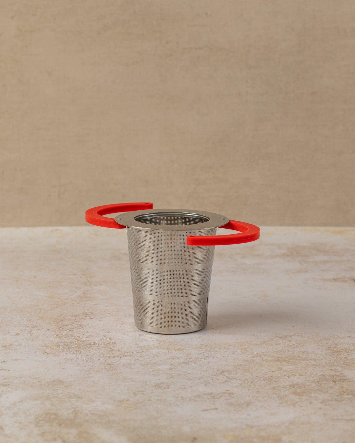 Collapsible stainless steel tea filter with silicone handles, by The Tea House