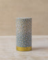 Cylindrical tea caddy with white and gold floral pattern over blue base, by The Tea House